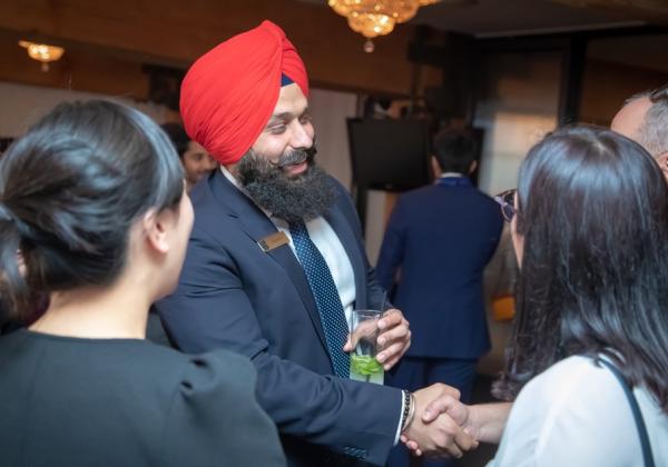 A business man meeting students at a networking event