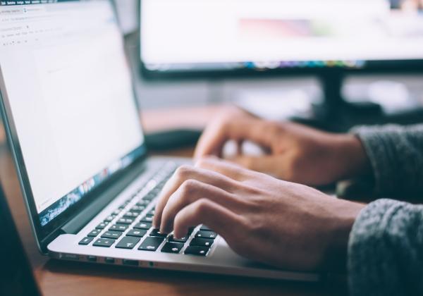 Hands on a laptop keyboard