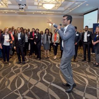 Attendees listening to a student speak at the 2019 Business Mixer at the Coast Bastion Hotel