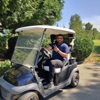 Shaurya Ahuja driving a golf cart at the Chamber of Commerce Golf Tournament